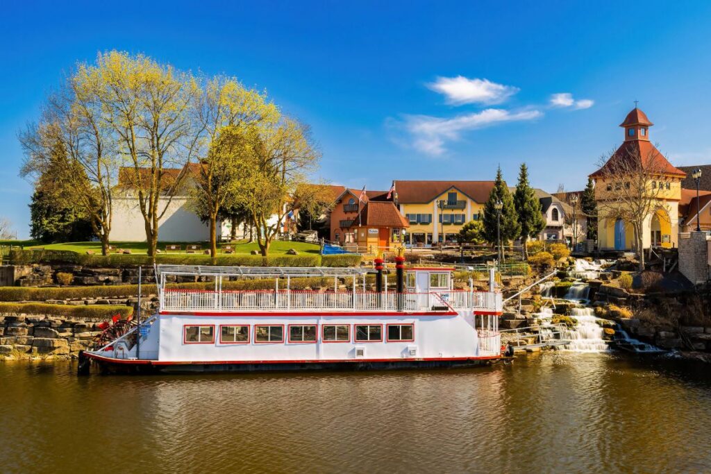 Bavarian Belle paddlewheel riverboat docked on the Cass River at the River Place Shops waterfall in Frankenmuth, Michigan.