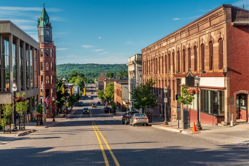 Downtown Marquette, Michigan from a hilltop street, showing the sandstone Marquette County Savings Bank building and the city's historic Washington Street corridor