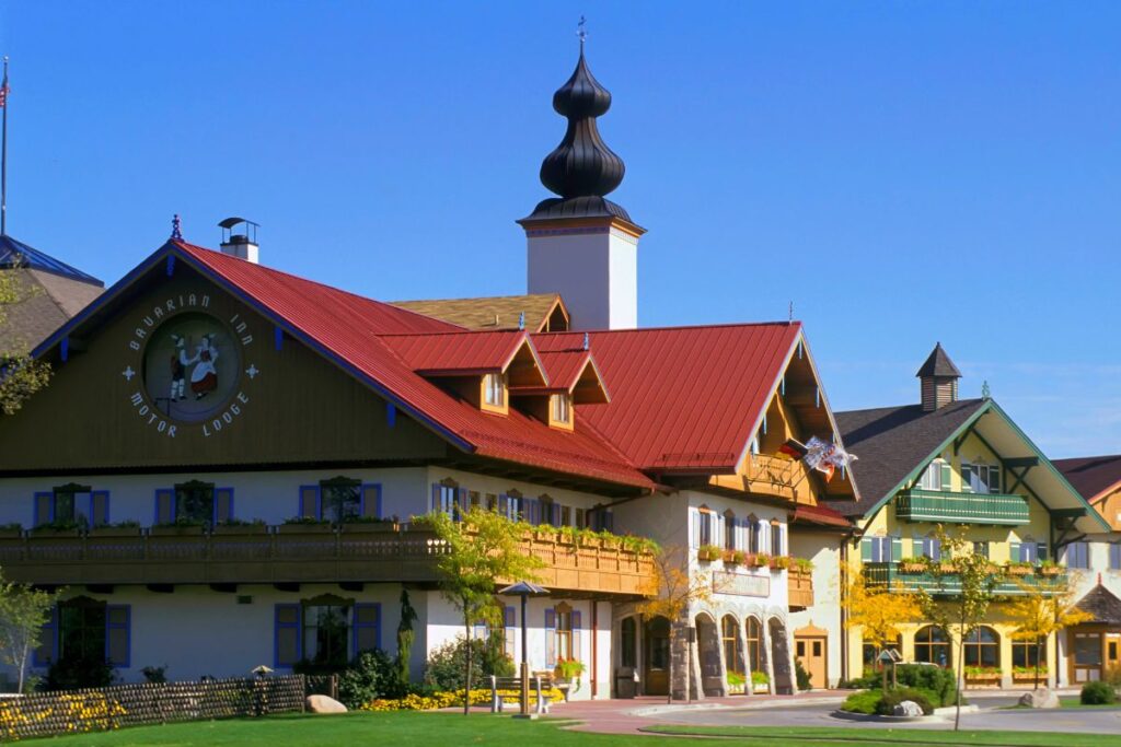 Traditional Bavarian-style architecture on Main Street in Frankenmuth Michigan, featuring the Bavarian Inn Restaurant and floral displays.