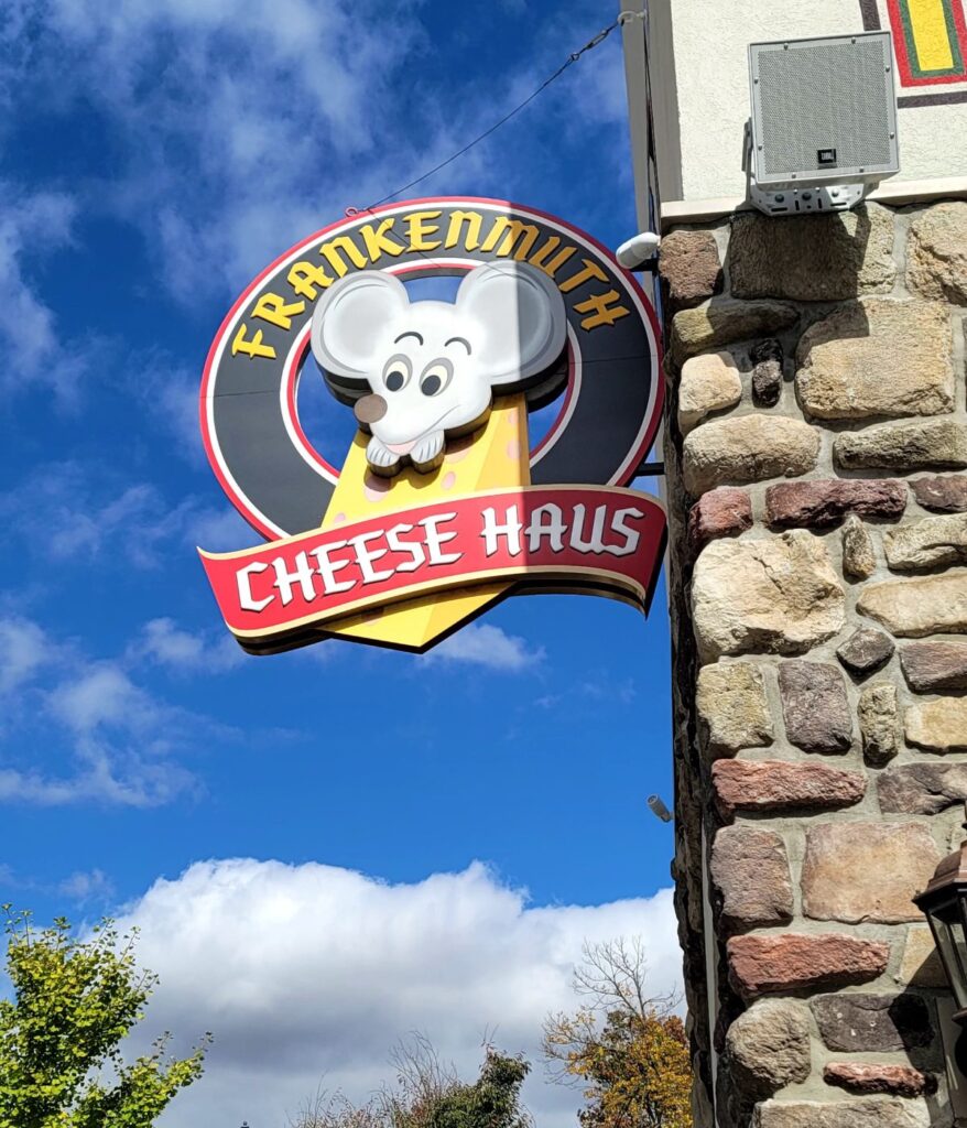 Frankenmuth Cheese Haus sign featuring Klaus the Cheese Haus Maus on Main Street in Frankenmuth, Michigan.