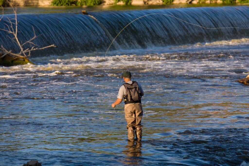 Person fishing near the fish ladder on the Grand River in Grand Rapids, Michigan