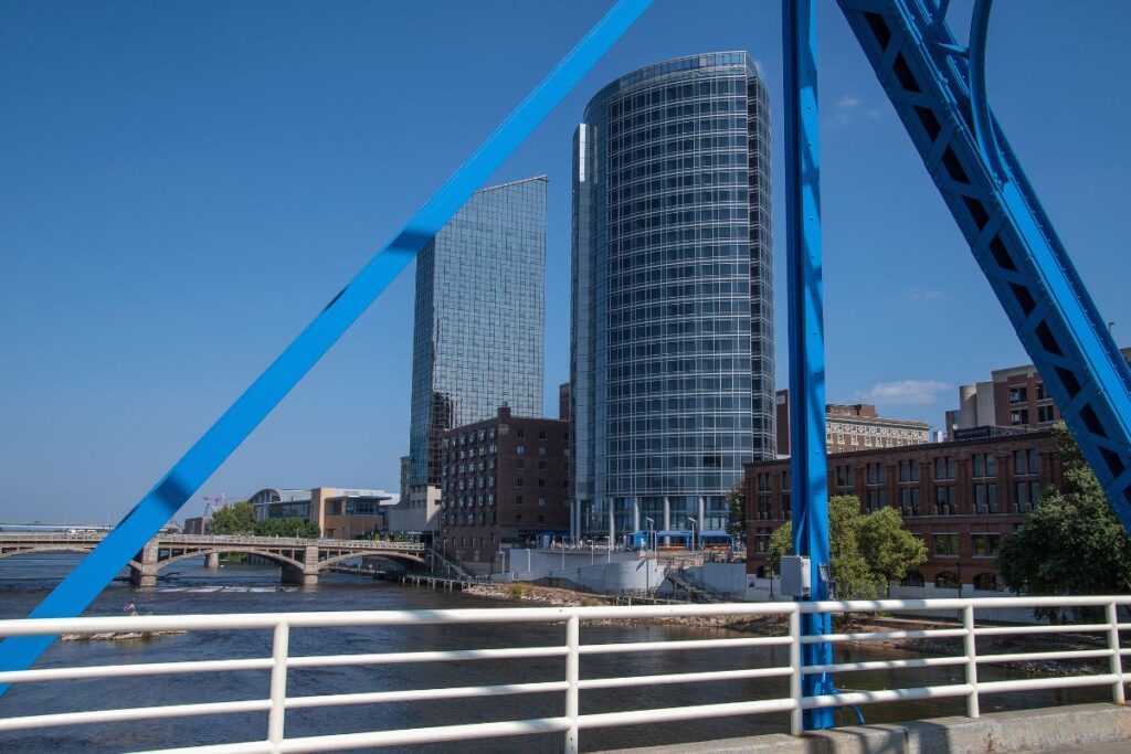 Downtown Grand Rapids skyline and Grand River viewed from a blue pedestrian bridge