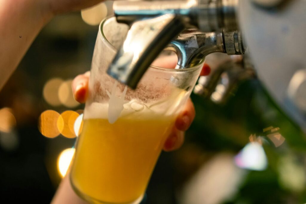 Bartender pouring a draft craft beer at a Grand Rapids brewery